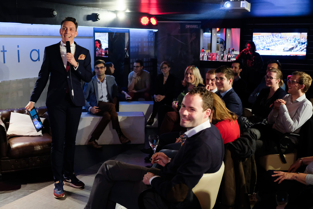 Presenter and audience laugh at a small event